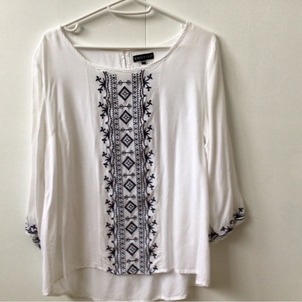 White blouse with black stitching detail